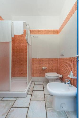 a bathroom with a shower and a toilet and a sink at Guest House Matteo in Torre Lapillo