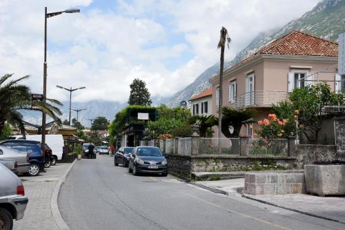a street in a town with cars parked on the road at Apartments Martiva in Kotor