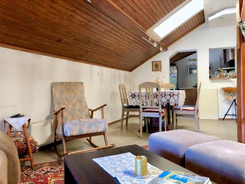 a living room with a couch and chairs and a table at Corner house apartment in Montana