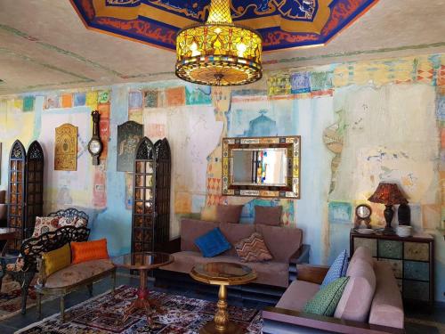 a living room with a couch and a chandelier at Ana's Apartment in Chakvi Oasis in Chakvi