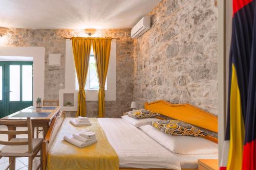 a bedroom with a large bed and a table at Golden Bay Hvar in Hvar