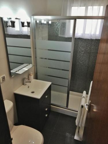 a bathroom with a shower and a toilet and a sink at Atlantic house in Gaula