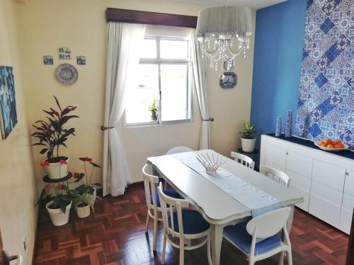 a kitchen and dining room with a white table and chairs at Atlantic house in Gaula