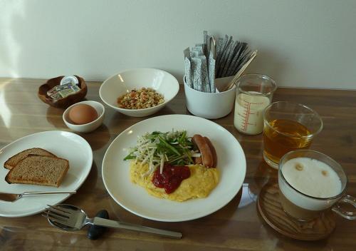 a wooden table topped with plates of food and drinks at Kanaloa Funabashi in Funabashi