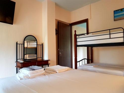a bedroom with two bunk beds and a mirror at Katina's House in Vourvourou