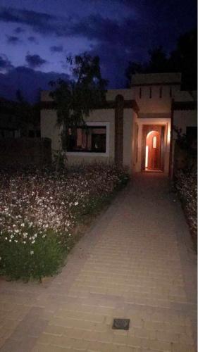 a house with a pathway leading to a door at night at VILLA 186 AGADIR in Islane