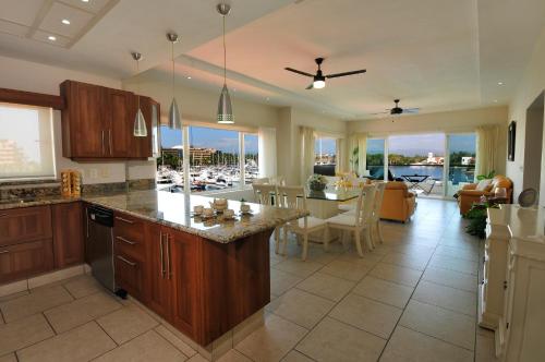 a large kitchen with a dining room and a living room at Marina Banderas Suites Hotel Boutique in Nuevo Vallarta