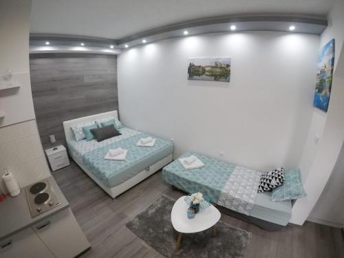 a room with a bed and a couch and a table at Apartman DMD in Trebinje