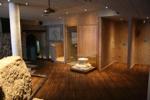a room with a glass table on a wooden floor at Hotel Spa La Casa Mudéjar in Segovia