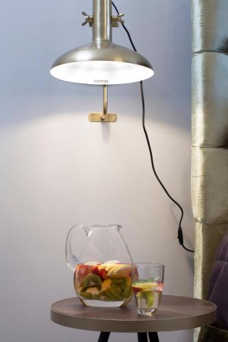 a table with a bowl of fruit and a lamp at Avra Private Suites in Lassi