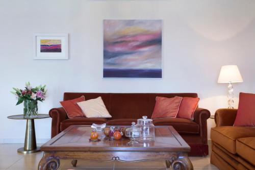 a living room with two couches and a coffee table at Avra Private Suites in Lassi