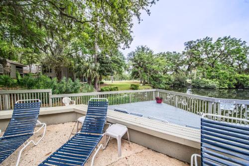 a deck with chairs and a table and water at Saint Andrews Common 1774 in Hilton Head Island