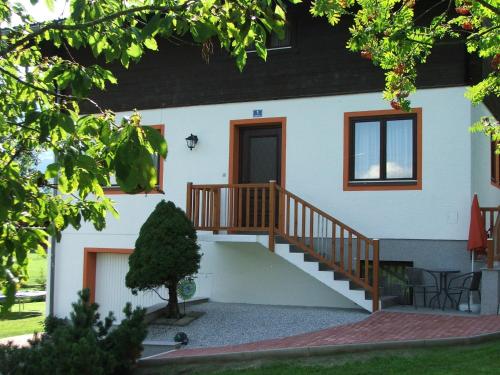 a house with a staircase in front of it at Appartment Sonnenschein in Uttendorf