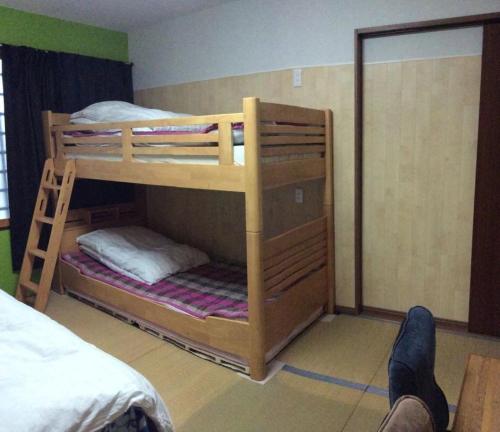 two bunk beds in a room with a person laying on the floor at Gaisei Building 3F / Vacation STAY 4092 in Kyoto