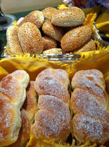 a bunch of donuts with powdered sugar on them at Hotel Sicilya in San Vito lo Capo