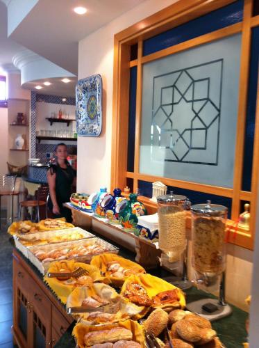 a person taking a picture of a buffet of food at Hotel Sicilya in San Vito lo Capo