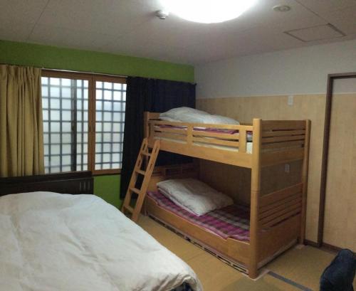 a bedroom with two bunk beds and a bed at Gaisei Building 3F / Vacation STAY 4092 in Kyoto