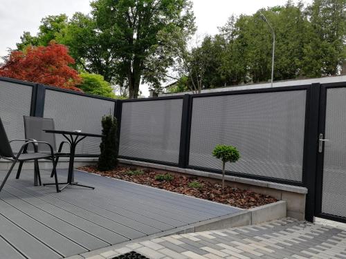 a black fence with white blinds on a patio at Apartmány Duo in Dačice