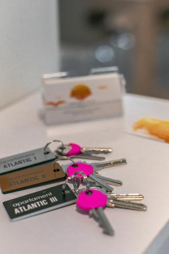 a bunch of pink keys sitting on a table at Apartamenty4you - Apartamenty Atlantic in Sopot