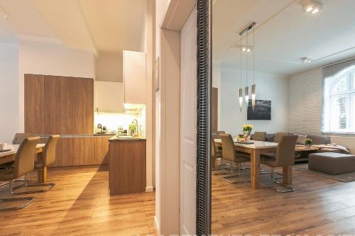 a dining room and kitchen with a table and chairs at Apartamenty4you - Apartamenty Atlantic in Sopot