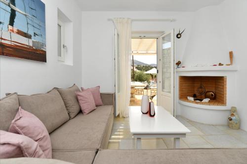 a living room with a couch and a fireplace at Villa Dinos in Aliki