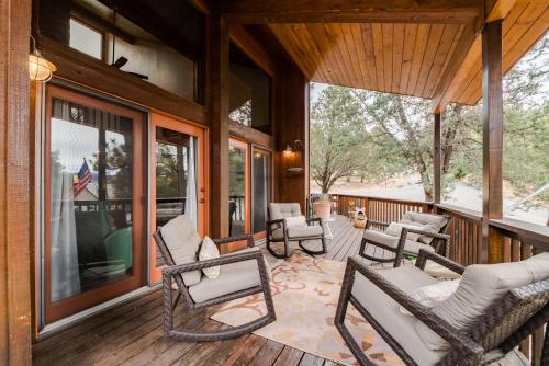 a screened in porch with rocking chairs and windows at High Loop in Ruidoso