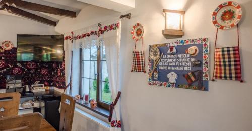 a kitchen with christmas decorations on the wall at La Conacul Vesel Săpânța in Săpînţa