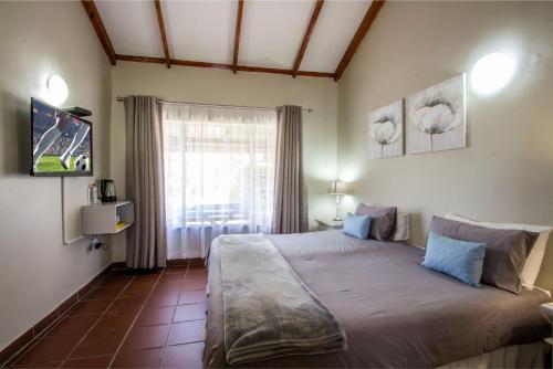 a bedroom with a large bed and a window at Patterson B&B in Newcastle