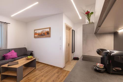 a living room with a couch and a table at ImPuls | aparts in Schladming