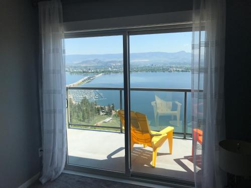 a room with a window with a view of the water at Lake and Bridge View Vacation Home in West Kelowna