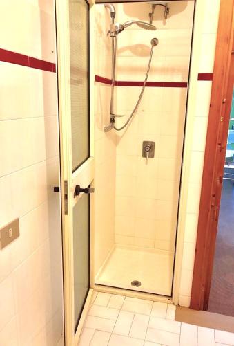 a shower with a glass door in a bathroom at Apartment Arianna 150mt from beach in Castelsardo