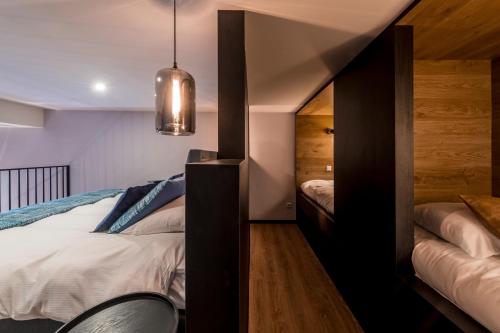 a small bedroom with a bed and a closet at Palace Hotel Zandvoort in Zandvoort