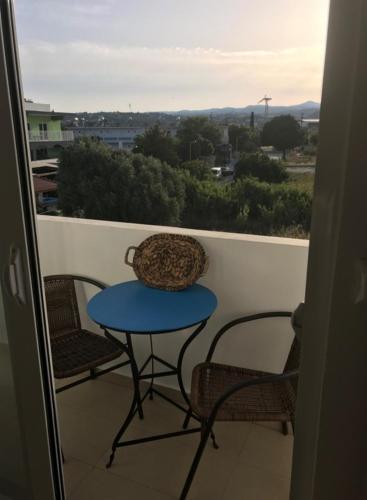 a table and chairs on a balcony with a view at Kostas Studios in Faliraki
