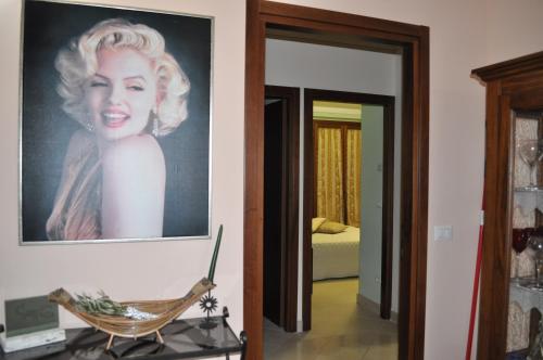 a painting of a woman on the wall in a room at La terrazza da Barbara in Torrita di Siena