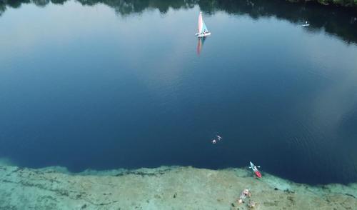 an aerial view of a sail boat in the water at Casa Lamat in Bacalar