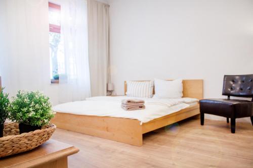 1 dormitorio con 1 cama y 1 silla en Apartment Dora, en Chemnitz