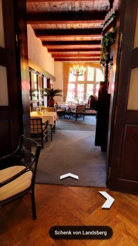 a room with tables and chairs in a building at Hotel & Restaurant Schenk von Landsberg in Teupitz