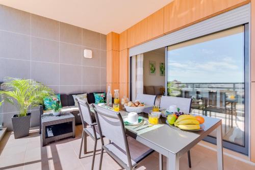 a dining room with a table with fruit on it at Ria House - beautiful apartment with swiming pool in Olhão