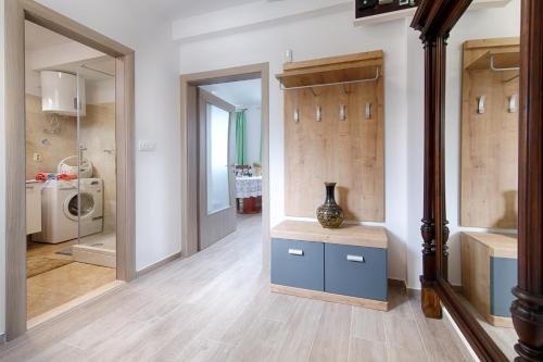 a hallway with a vase on a table in a room at Seaview apartment Bambo in Komiža