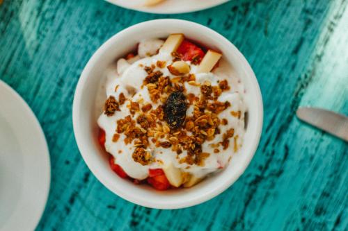 a bowl of yogurt with fruit and nuts on a table at Ensueño Holbox & Beach Club in Holbox Island