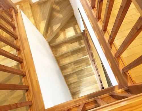 a spiral staircase in a house with wooden floors at Guest House Chaconne Karuizawa in Karuizawa