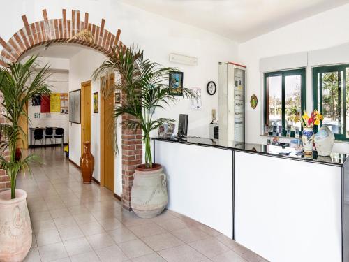 a kitchen with a counter and plants in a room at Villaggio Alkantara in Giardini Naxos