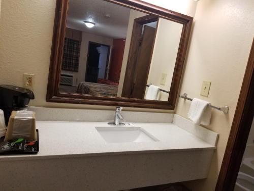 a bathroom with a sink and a mirror at Eufaula Inn in Eufaula