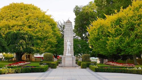 a monument in a park with flowers and trees at Cambridge Mews Motel in Cambridge