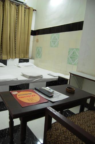 a room with a table with a remote control on it at Sai Palace in Agra