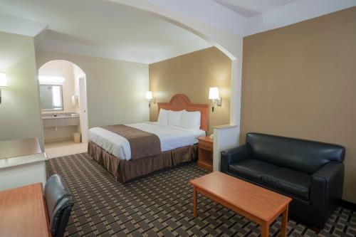 a hotel room with a bed and a chair at Motel 6-Tyler, TX in Tyler