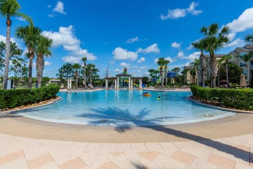 a swimming pool at a resort with palm trees at Windsor Hills Resort 5BR Villa, Amenities, Private Pool & Water Park, Near Disney, Sea World, Universal in Orlando