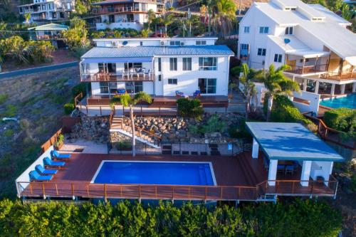 an aerial view of a house with a swimming pool at Nautilus On The Hill - Airlie Beach in Airlie Beach