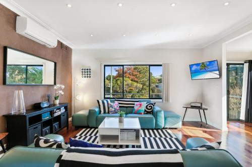 a living room with a couch and a table at The Bud House in Rosebud