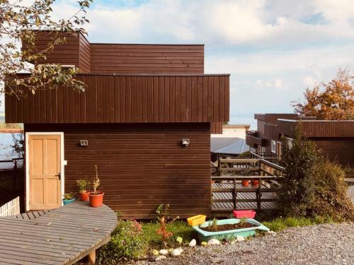 a small wooden building with a wooden deck at Dulac Futrono in Futrono